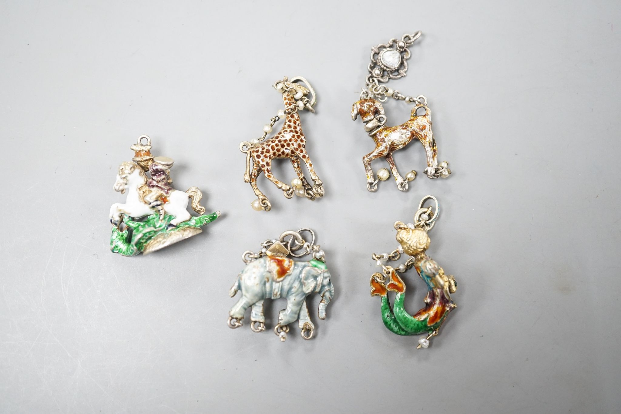 Five assorted Austro-Hungarian style gilt white metal and enamel pendants/fob seal etc. including mermaid, giraffe and elephant, giraffe 32mm.